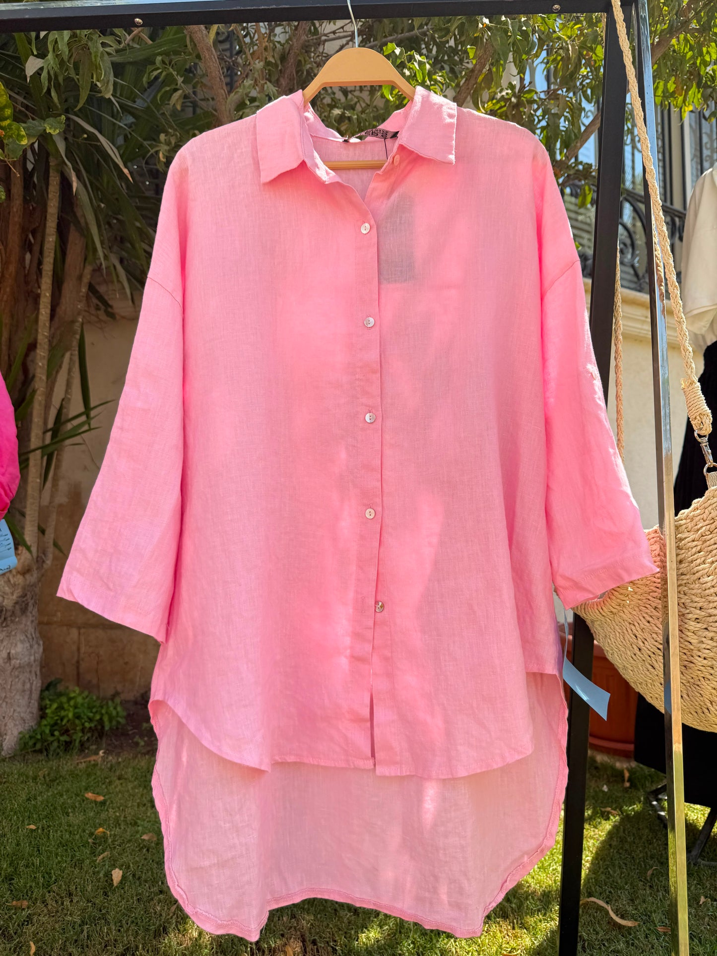 Amenaa linen shirt displayed on a hanger, showing lightweight, breathable fabric with a relaxed fit and classic collar.
