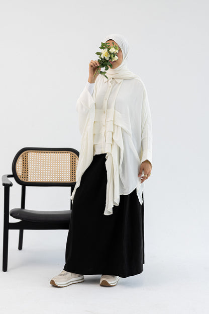 Amenaa ruffles blouse featuring soft fabric, feminine ruffle details, and a stylish, casual fit suitable for everyday wear.
