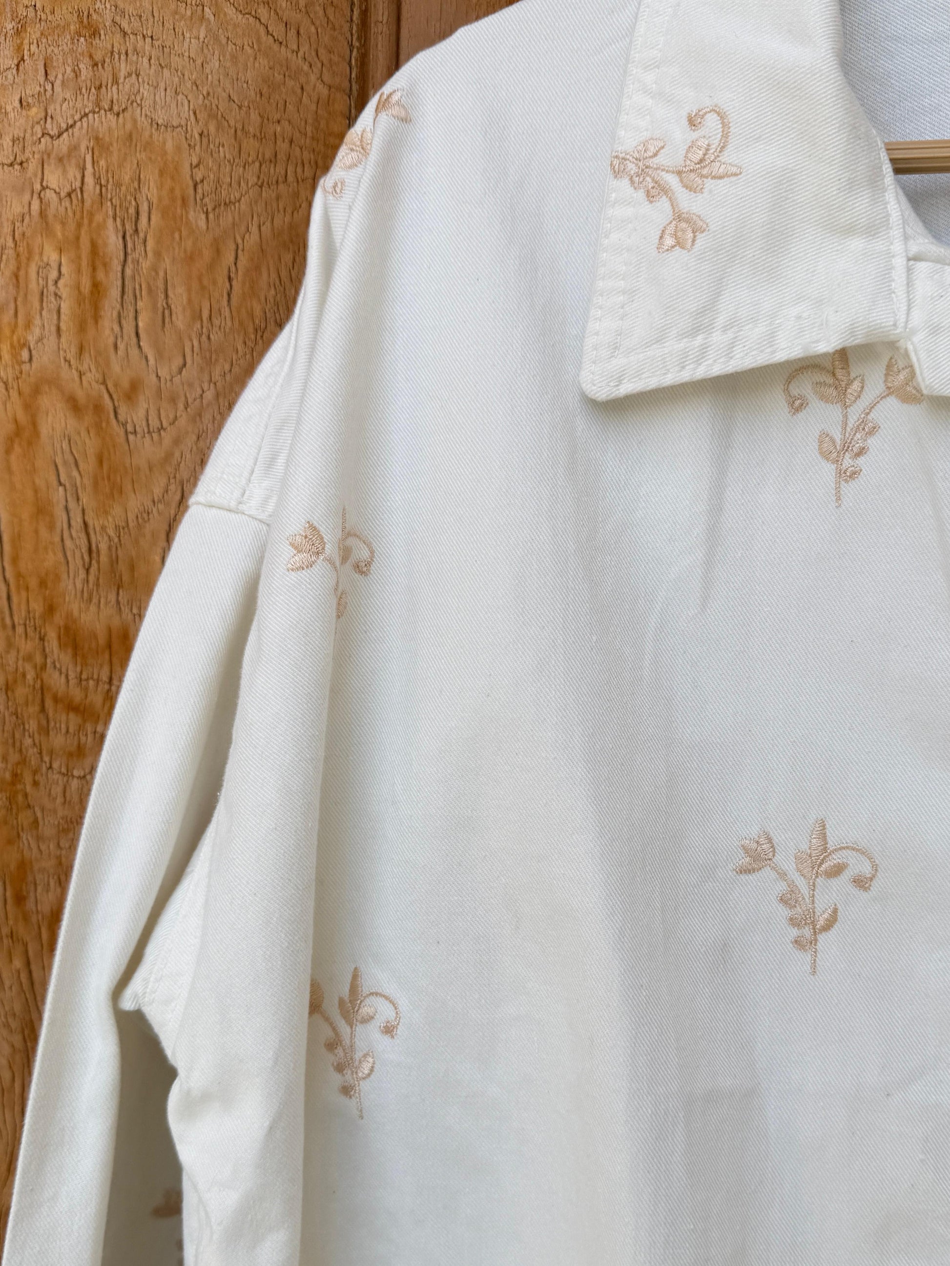 Flowery embroidered gabardine jacket by Amenaa, showing detailed floral embroidery and tailored fit in a stylish outerwear design.