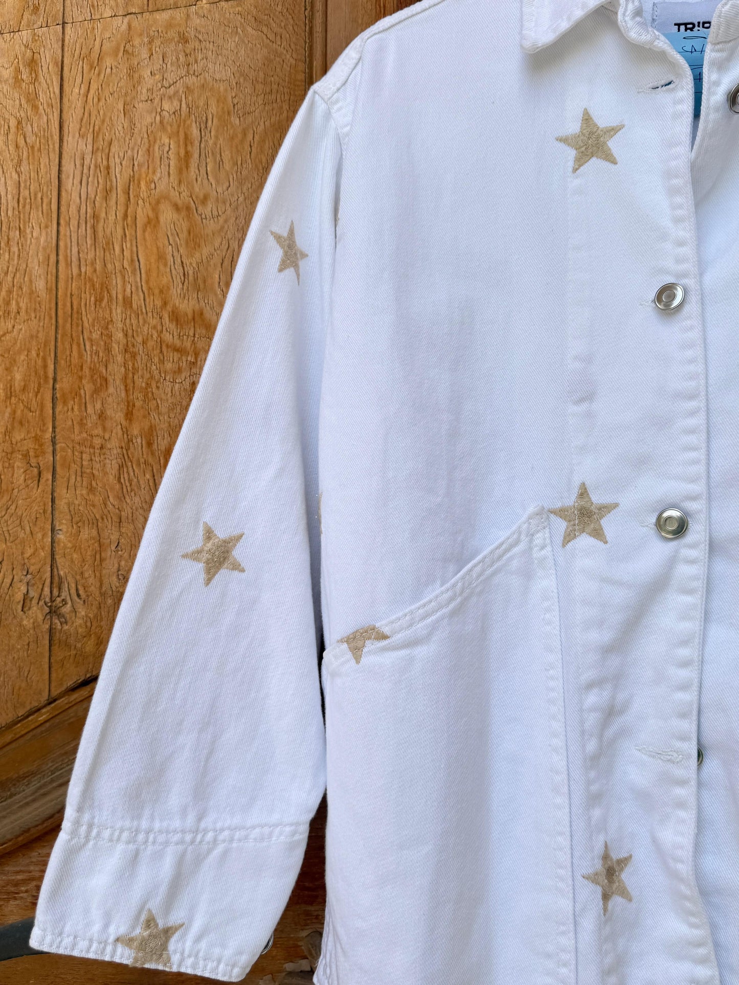 Amenaa Star Gabardine Jacket displayed on a hanger, featuring a stylish dark gabardine fabric with star accents.
