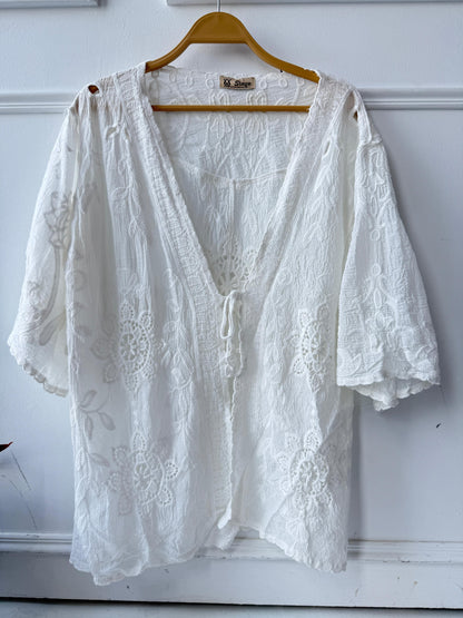 Amenaa embroidered lace kimono featuring delicate floral embroidery and flowing fabric, styled with open front and wide sleeves.