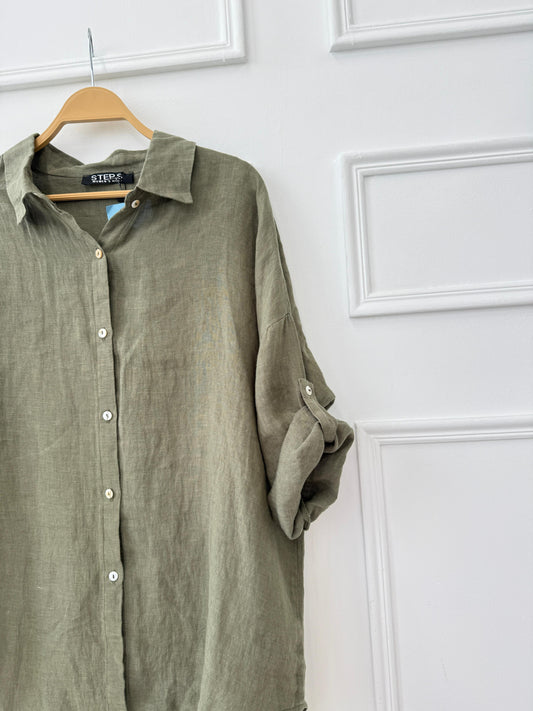 Light beige Amenaa linen shirt displayed on a hanger, showcasing its breathable fabric and casual, relaxed fit.