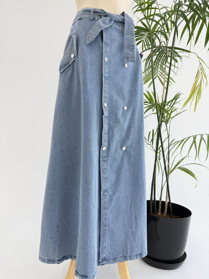 Amenaa button denim skirt with front pockets and a high-waist design, showcasing classic blue denim fabric and button details.
