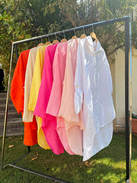 Light beige linen shirt by Amenaa displayed on a hanger, showcasing its relaxed fit and natural fabric texture.