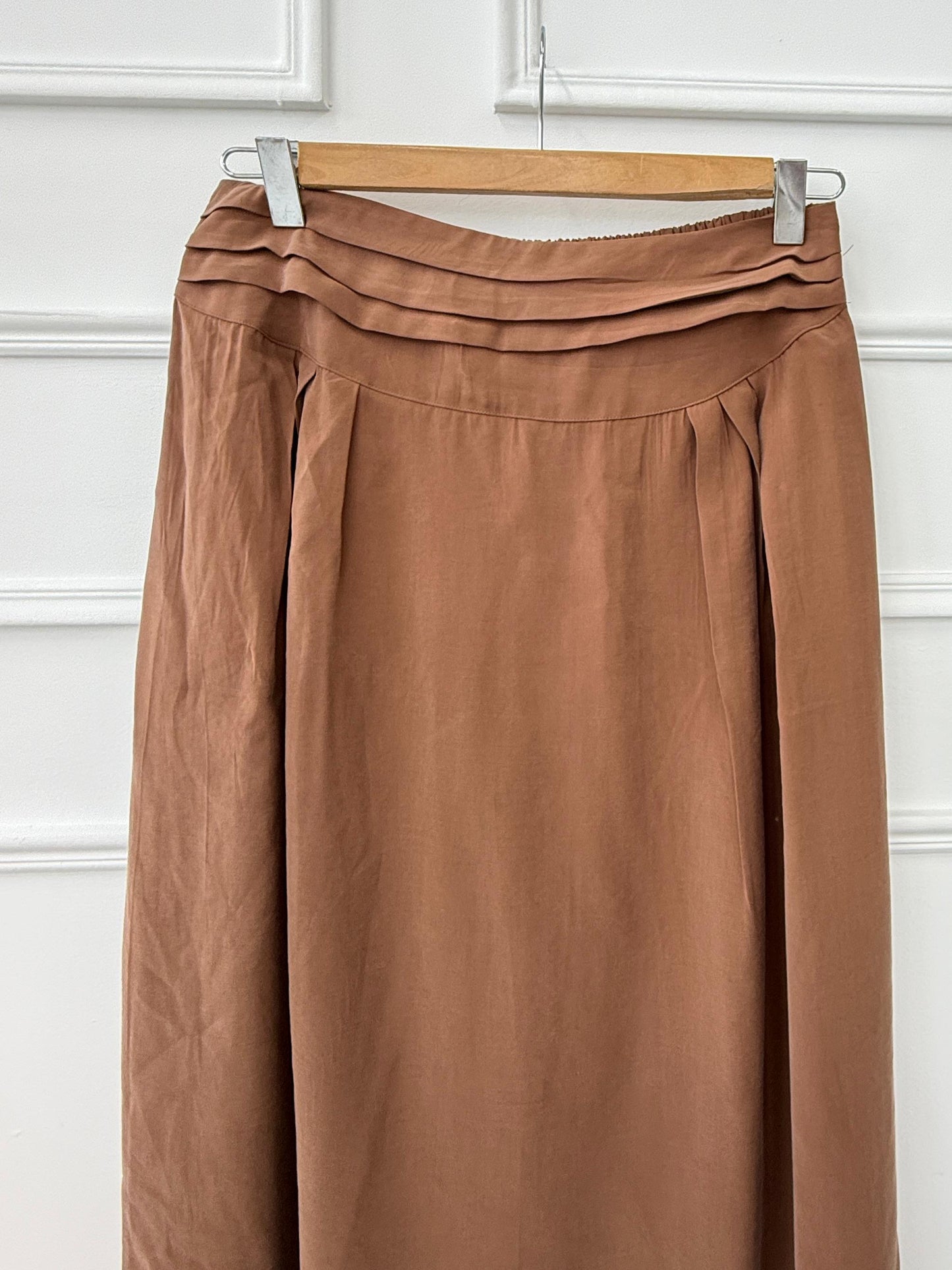 Amenaa new skirt featuring stylish fabric and a flattering fit, displayed on a hanger against a neutral background.