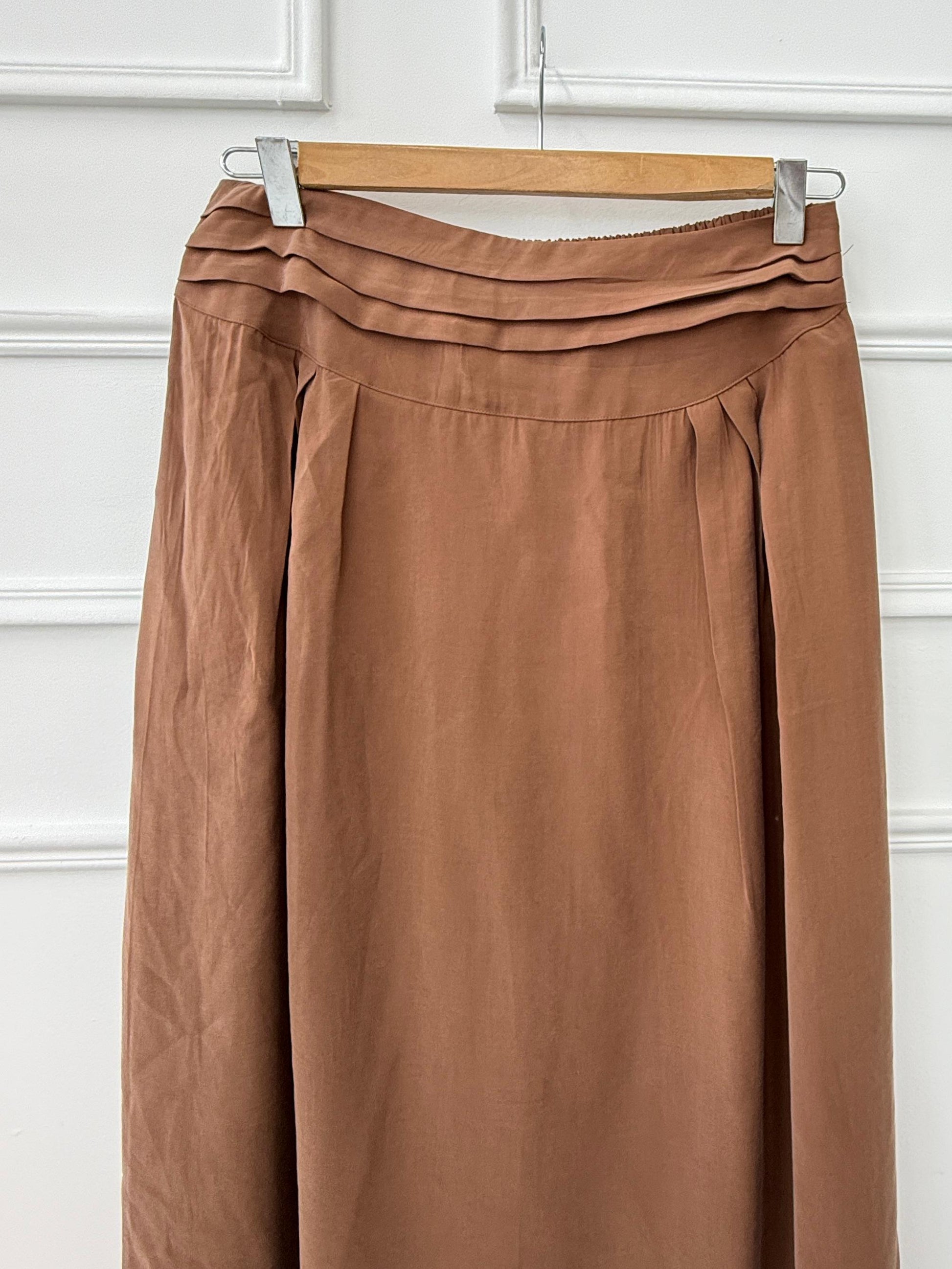 Amenaa new skirt featuring stylish fabric and a flattering fit, displayed on a hanger against a neutral background.