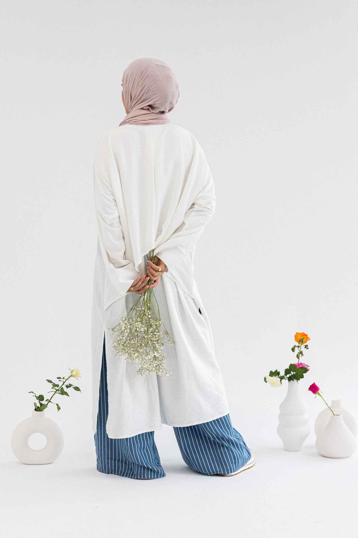 Amenaa high-low shirt dress featuring a flowing silhouette and collar, shown in a stylish, casual wear setting.