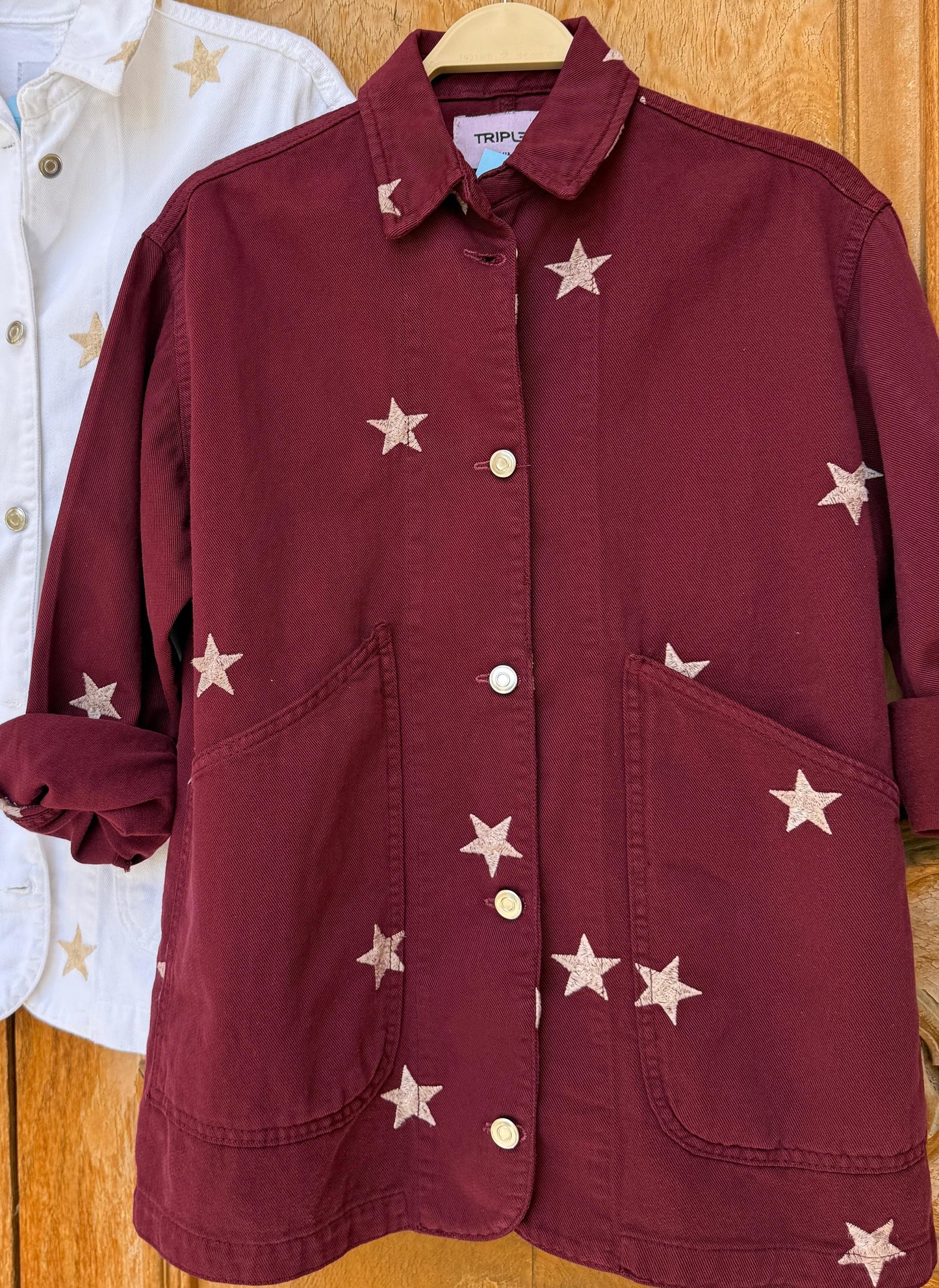 Amenaa Star Gabardine Jacket displayed on a hanger, featuring a stylish star pattern and classic gabardine fabric in neutral tones.