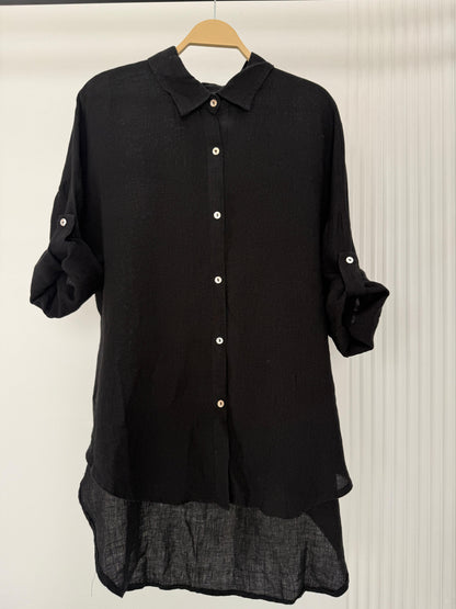 Amenaa linen shirt displayed on a hanger, featuring lightweight, breathable fabric with a classic collar and button-up front.
