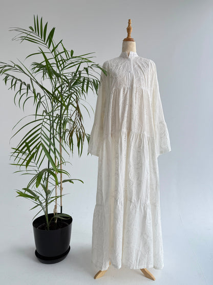 Amenaa Rokama Dress displayed on a mannequin, featuring a stylish, flowy design with vibrant patterns and elegant details.