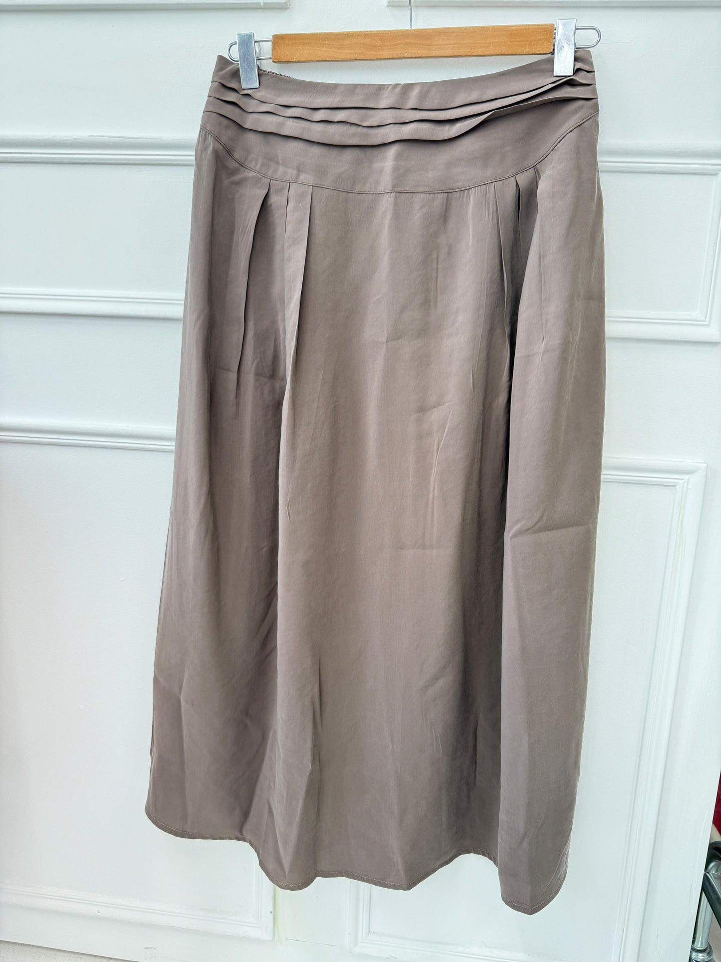 Amenaa new skirt displayed on a hanger, featuring a stylish design with a flattering fit and vibrant fabric.