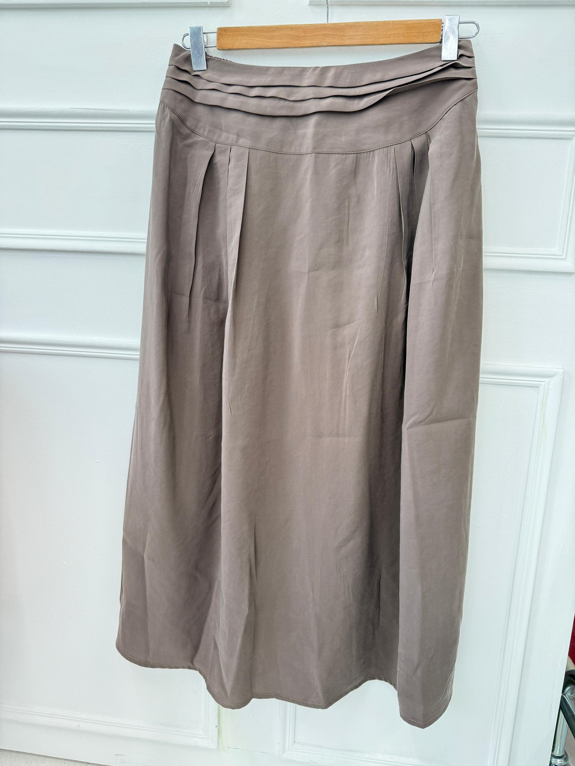 Amenaa new skirt displayed on a hanger, featuring a stylish design with a flattering fit and vibrant fabric.
