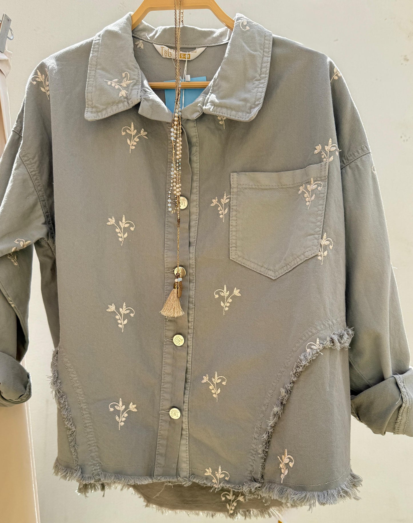 Flowery embroidered gabardine jacket by Amenaa featuring colorful floral embroidery and tailored fit.