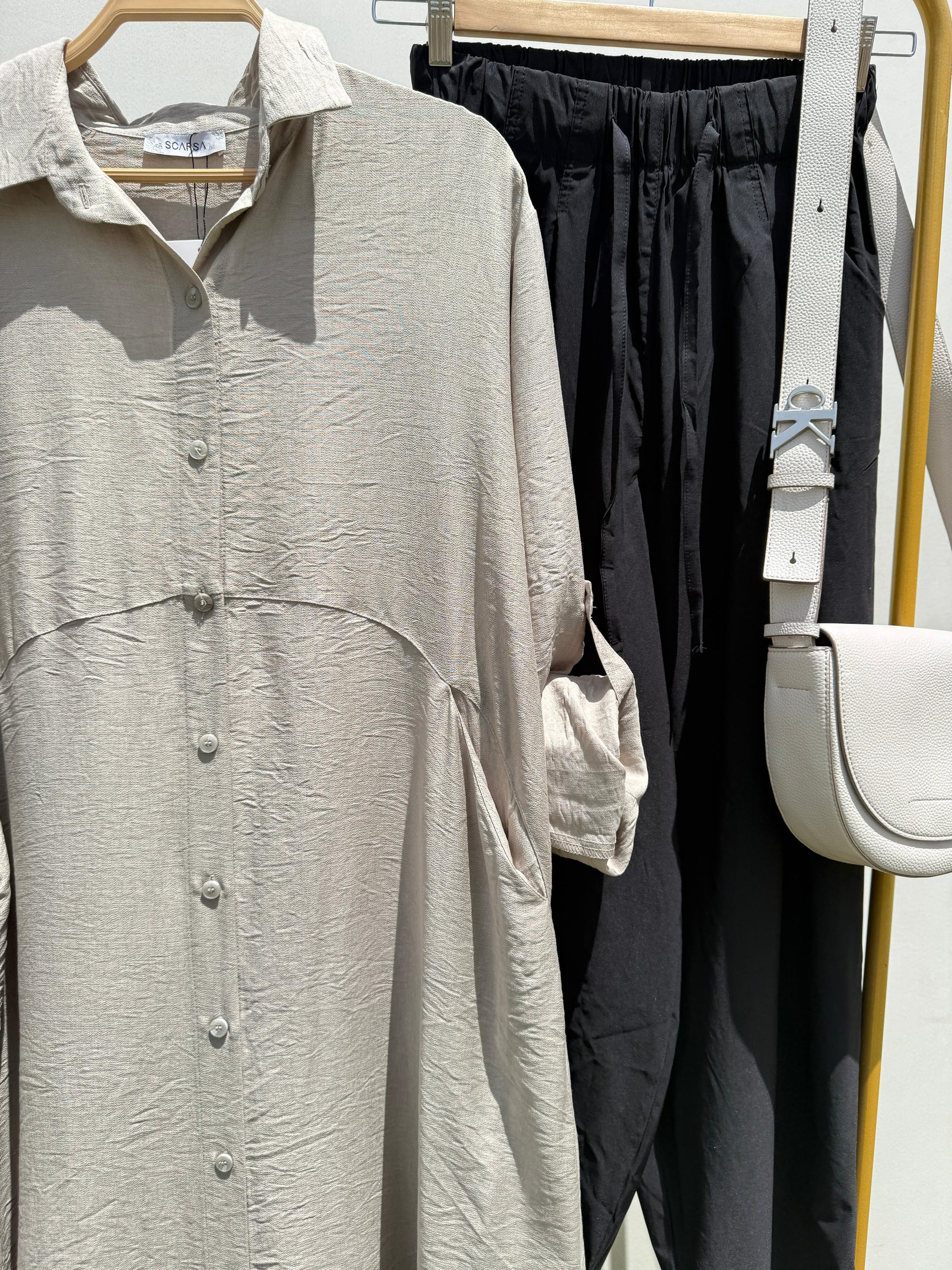 Amenaa shirt dress with a relaxed fit, featuring a collar, button-front, and short sleeves, displayed on a hanger.
