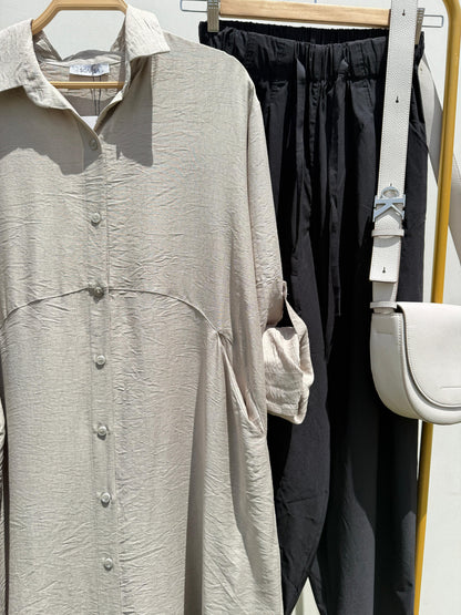 Amenaa shirt dress with a relaxed fit, featuring a collar, button-front, and short sleeves, displayed on a hanger.