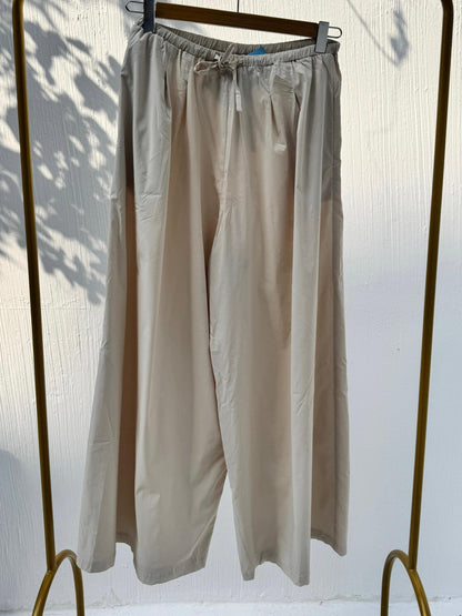 Amenaa wide leg pants in lightweight fabric, featuring a relaxed fit and high waist, styled with a casual top.