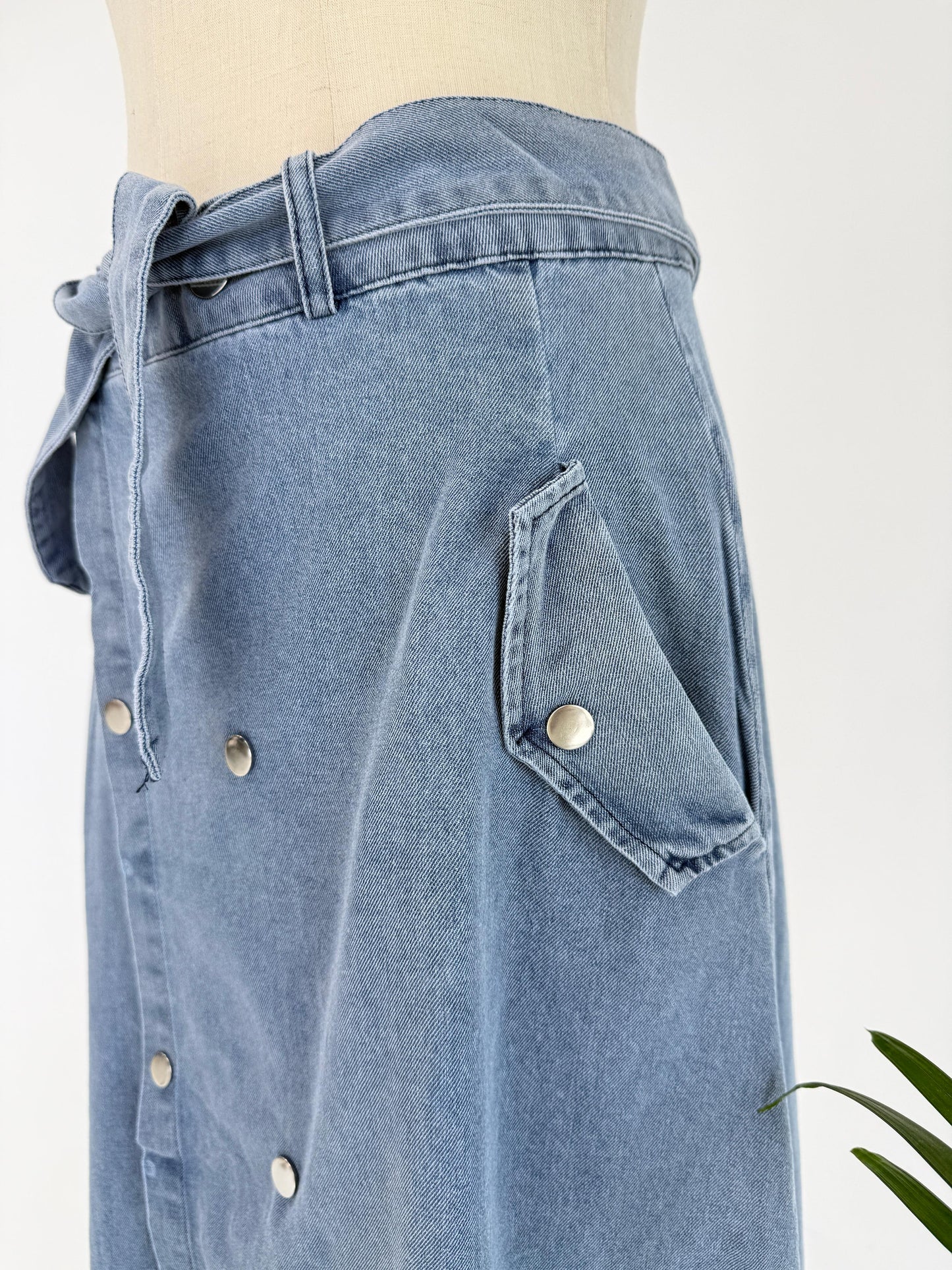 Amenaa button denim skirt with front buttons and classic denim wash, styled with a relaxed fit and casual design.