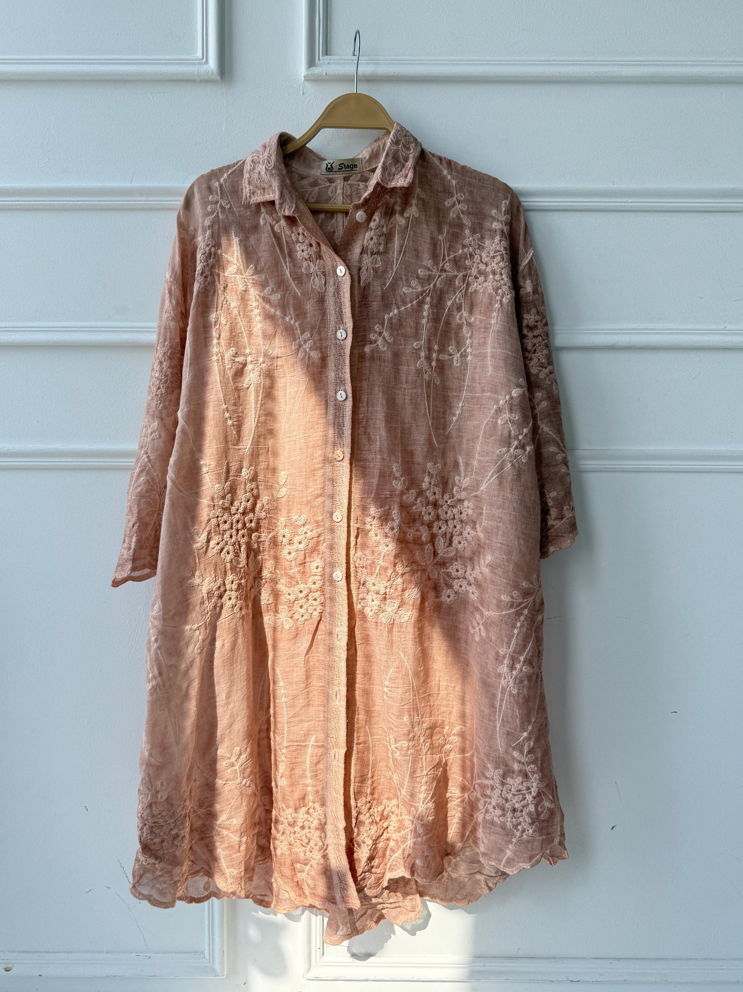 Embroidered Amenaa shirt featuring detailed floral embroidery on soft fabric, displayed on a hanger with a neutral background.