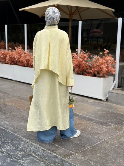 Amenaa high-low shirt dress featuring a flowing design with a collar and button front, perfect for casual or semi-formal wear.