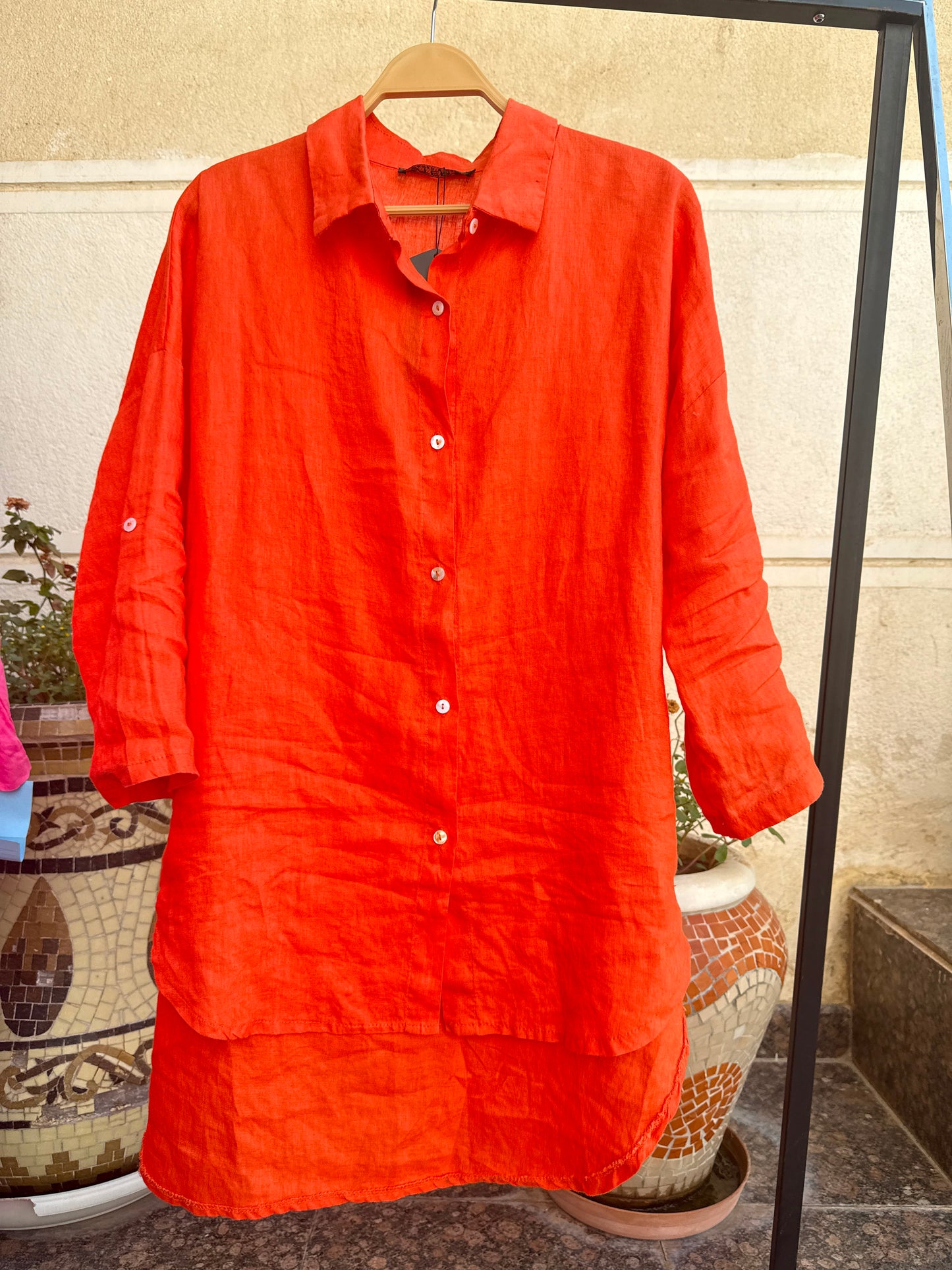 Light beige Amenaa linen shirt laid flat, showcasing its breathable, relaxed fit and natural fabric texture.