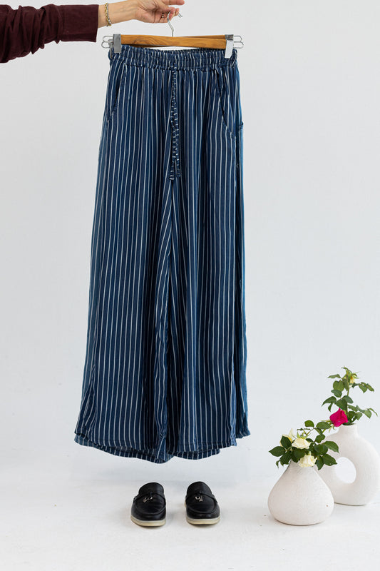 Amenaa striped pants in size 42 with blue and white vertical stripes, shown flat on a white background.