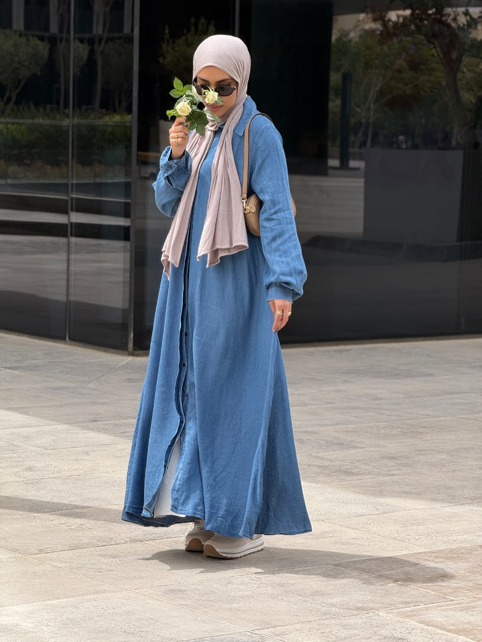 Amenaa maxi denim dress featuring a flowing silhouette, sleeveless design, and classic blue denim fabric.
