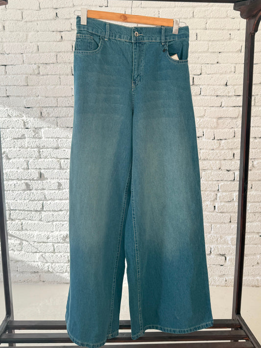 Women’s denim wide-leg pants by Amenaa, featuring a relaxed fit and classic blue denim fabric, shown on a model.