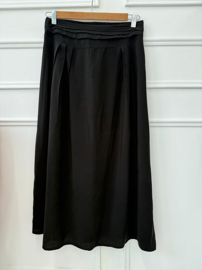 Light blue Amenaa skirt with a high waist and flowing fabric, shown on a model in a casual outdoor setting.