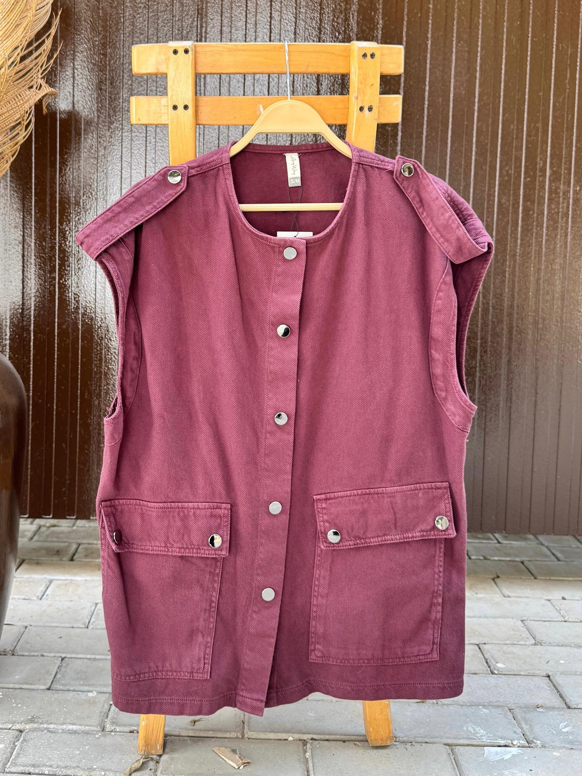 Amenaa new gabardine vest shown on a hanger, featuring a tailored design, classic collar, and button closure.