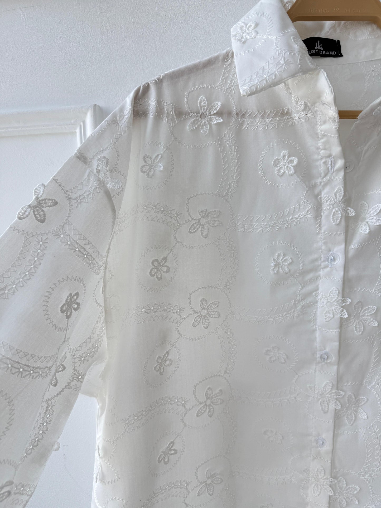 Floral embroidered Amenaa shirt with intricate colorful flower patterns on soft fabric, close-up view of detailed embroidery.