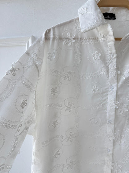 Floral embroidered Amenaa shirt with intricate colorful flower patterns on soft fabric, close-up view of detailed embroidery.