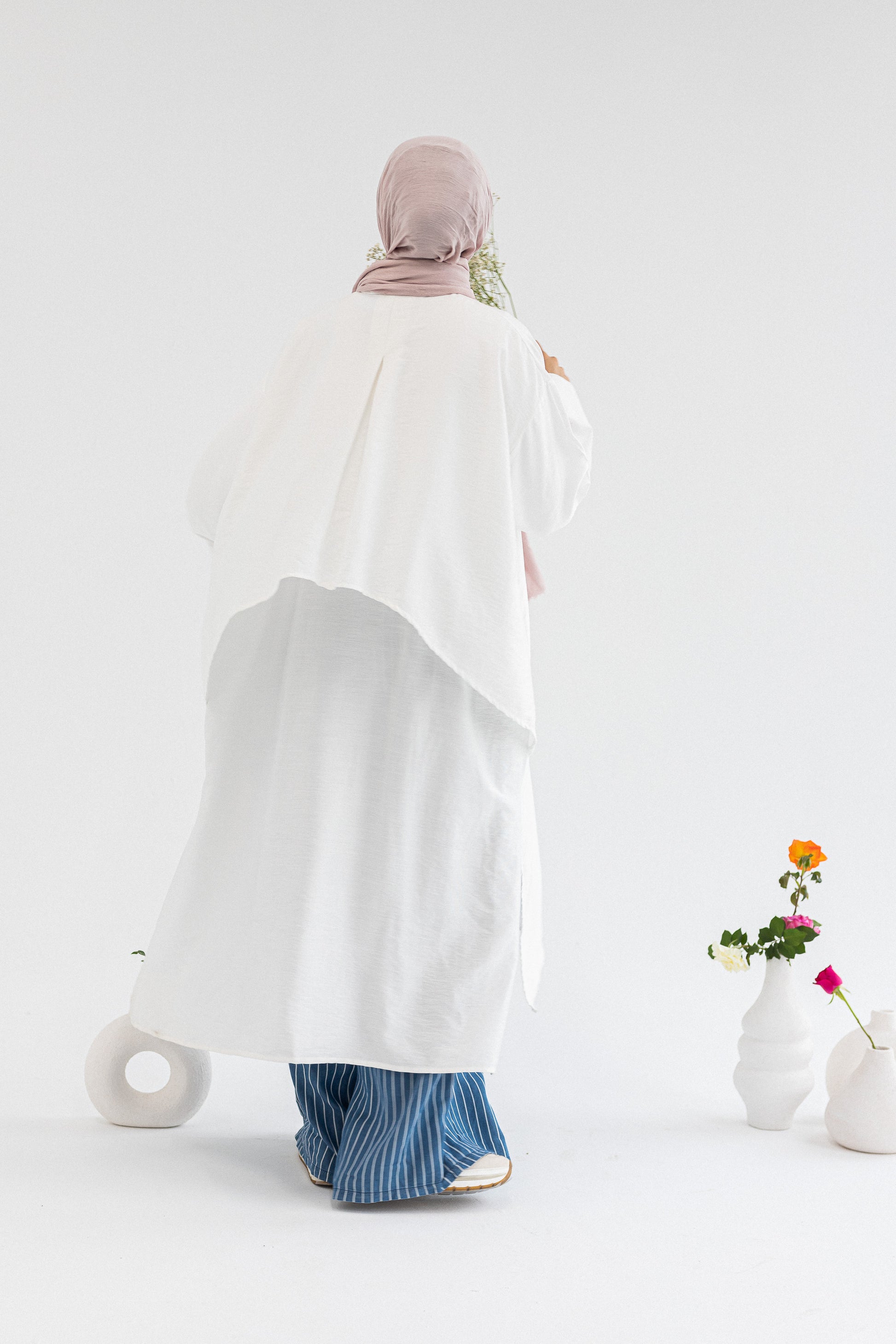 Amenaa high-low shirt dress shown in a casual style with a button-up front and long sleeves, perfect for everyday wear.