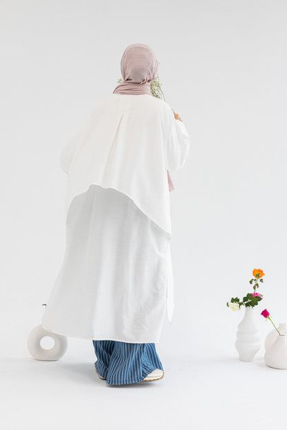 Amenaa high-low shirt dress shown in a casual style with a button-up front and long sleeves, perfect for everyday wear.