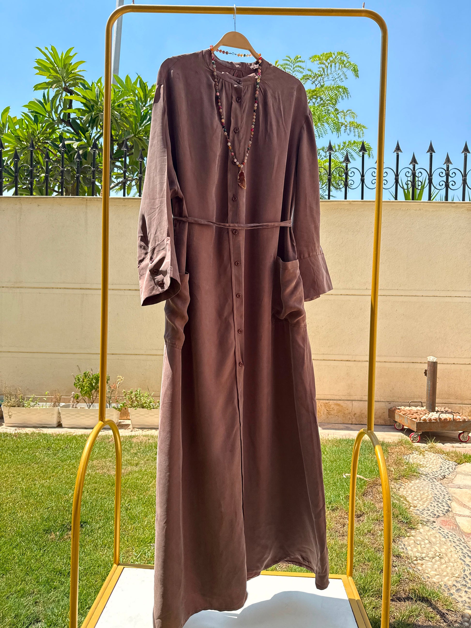 Elegant beige modest abaya by Amenaa featuring flowing fabric and subtle embroidery for a sophisticated Islamic fashion look.