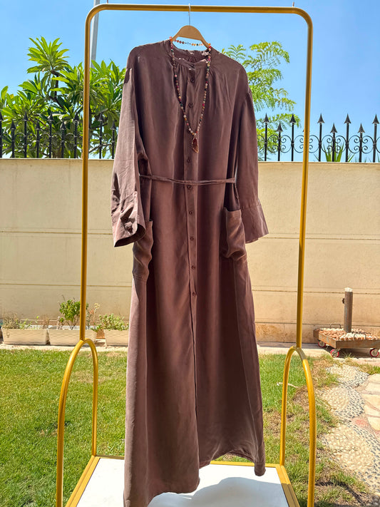 Elegant beige modest abaya by Amenaa featuring flowing fabric and subtle embroidery for a sophisticated Islamic fashion look.