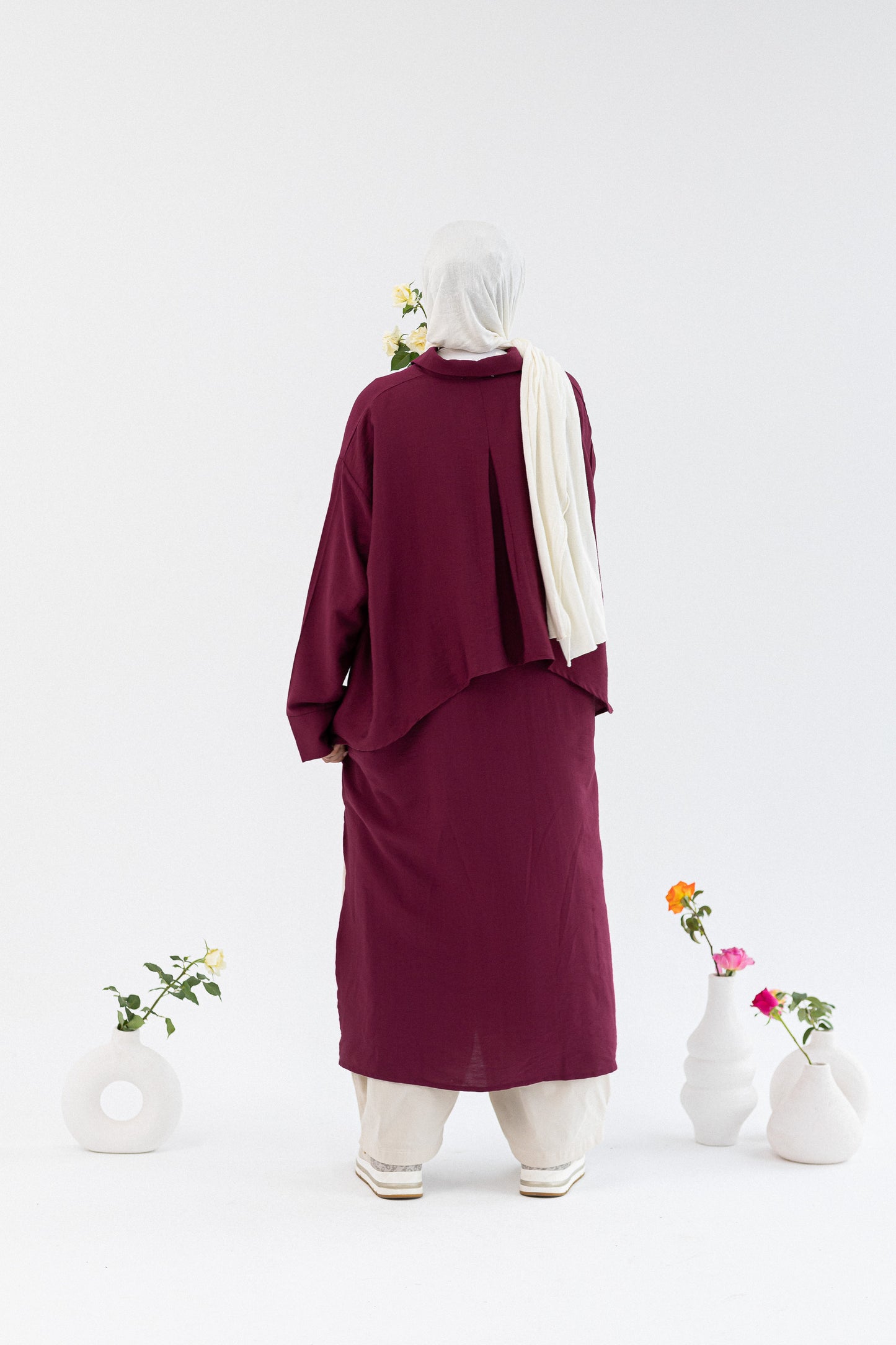 Amenaa high-low shirt dress featuring a flowing design with a collar and long sleeves, casual and stylish for everyday wear.
