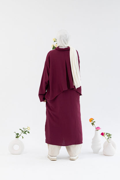 Amenaa high-low shirt dress featuring a flowing design with a collar and long sleeves, casual and stylish for everyday wear.