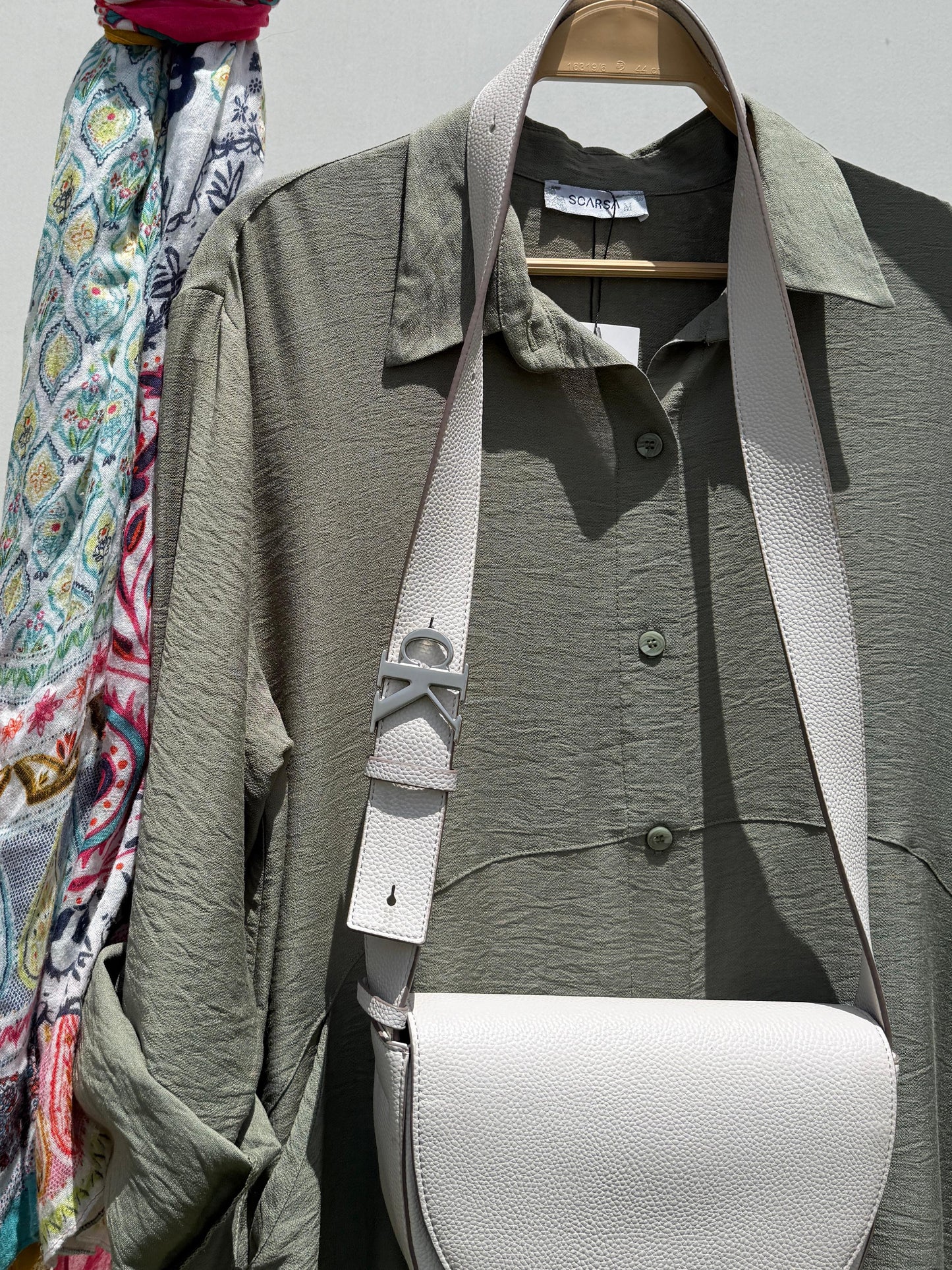 Amenaa shirt dress with a casual fit, featuring a collar, button front, and short sleeves, displayed on a hanger.