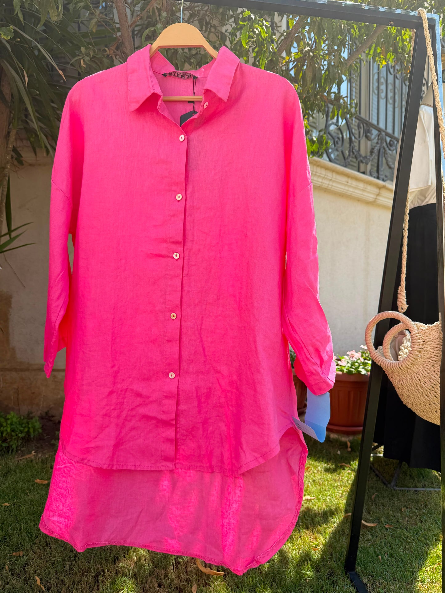 Amenaa linen shirt displayed on a hanger, featuring a lightweight, breathable fabric with a relaxed fit and classic collar.