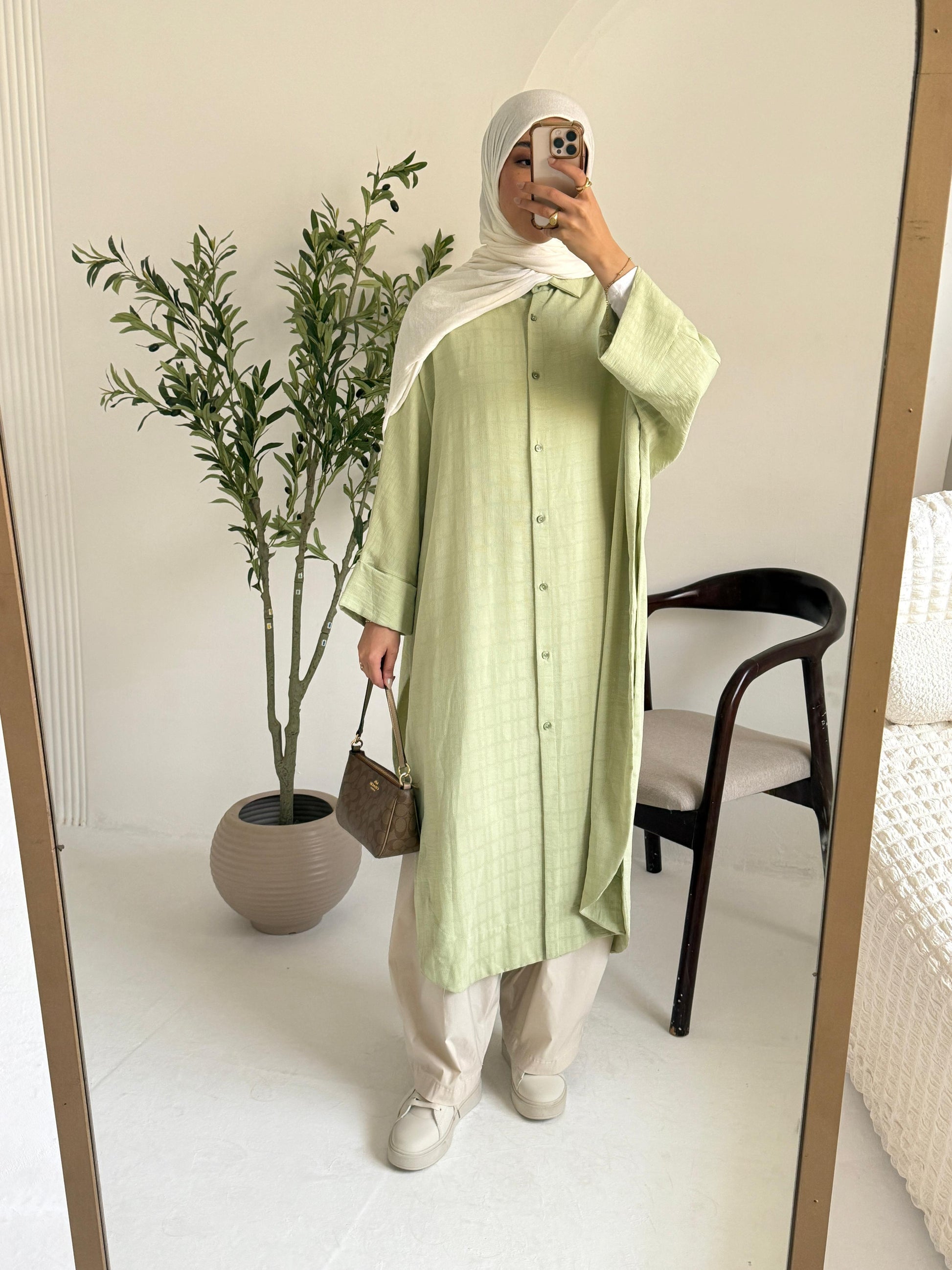 Amenaa textured oversized shirt dress displayed on a model, showcasing its relaxed fit and fabric details.