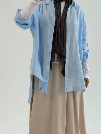 Amenaa linen shirt featuring a relaxed fit with long sleeves and a button-front design, displayed on a hanger.