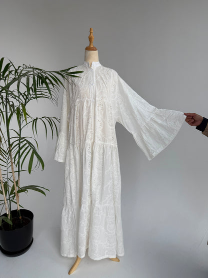 Amenaa Rokama dress displayed on a mannequin, featuring a stylish design with intricate details and vibrant fabric.