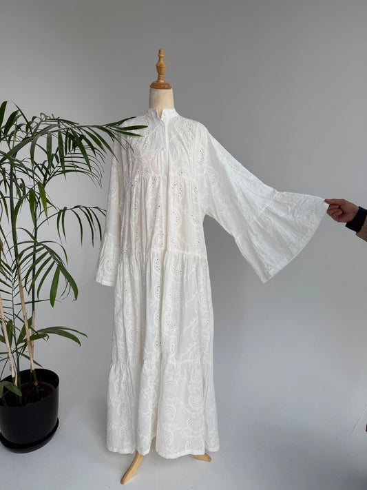 Amenaa Rokama dress displayed on a mannequin, featuring a stylish design with intricate details and vibrant fabric.