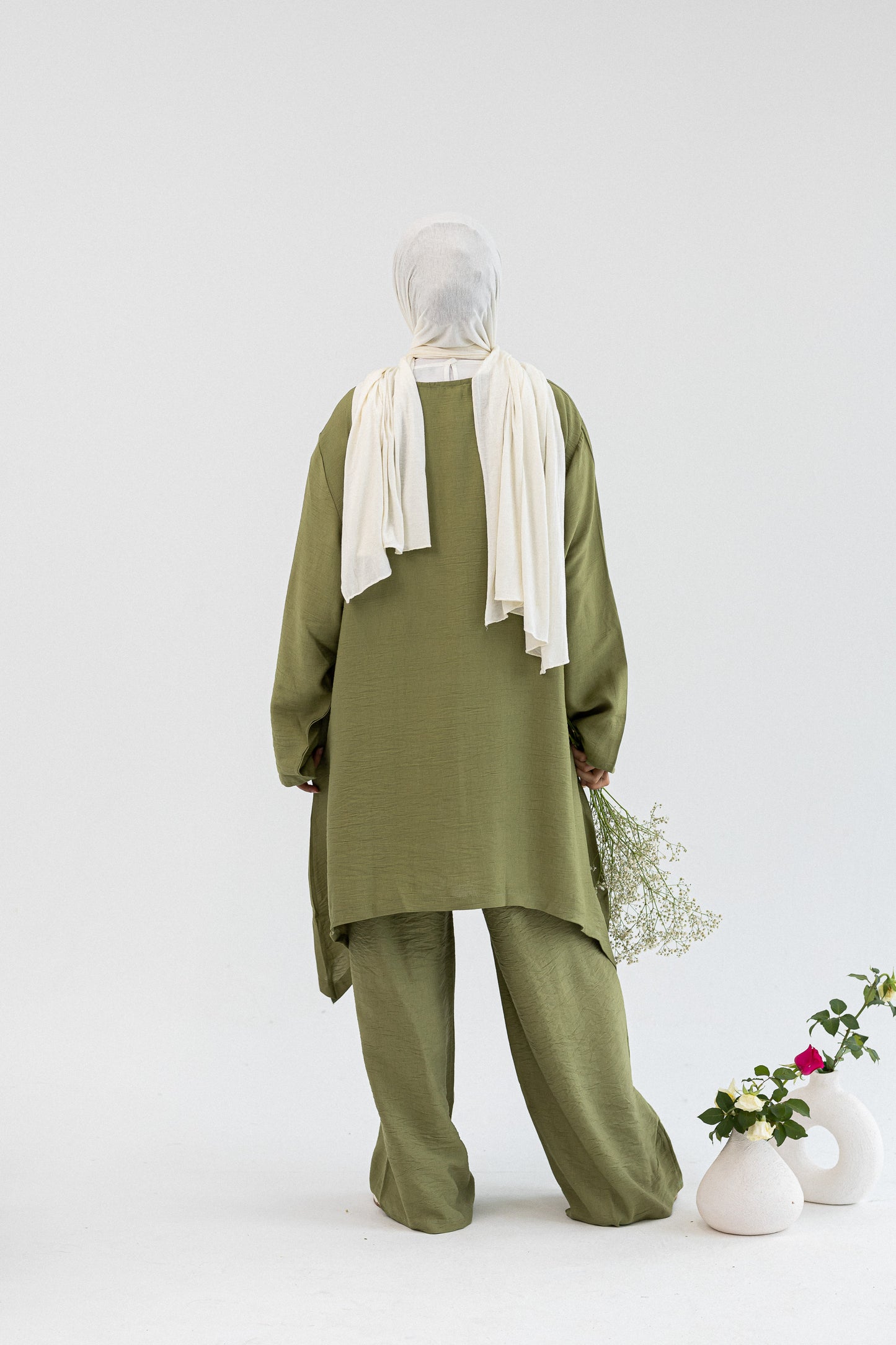 Amenaa Modest Set 1/12/13 featuring a stylish, modest clothing ensemble with layered fabric and elegant design details.