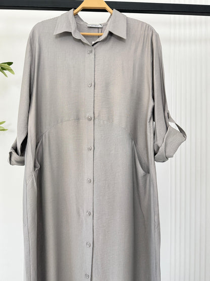 Light blue Amenaa shirt dress with a relaxed fit, featuring a collar, button-front, and knee-length hem.