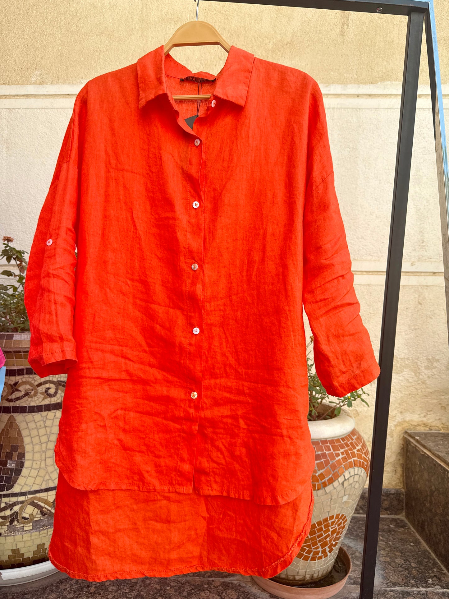 Amenaa linen shirt in soft, breathable fabric displayed on a hanger, showcasing its casual and lightweight design.