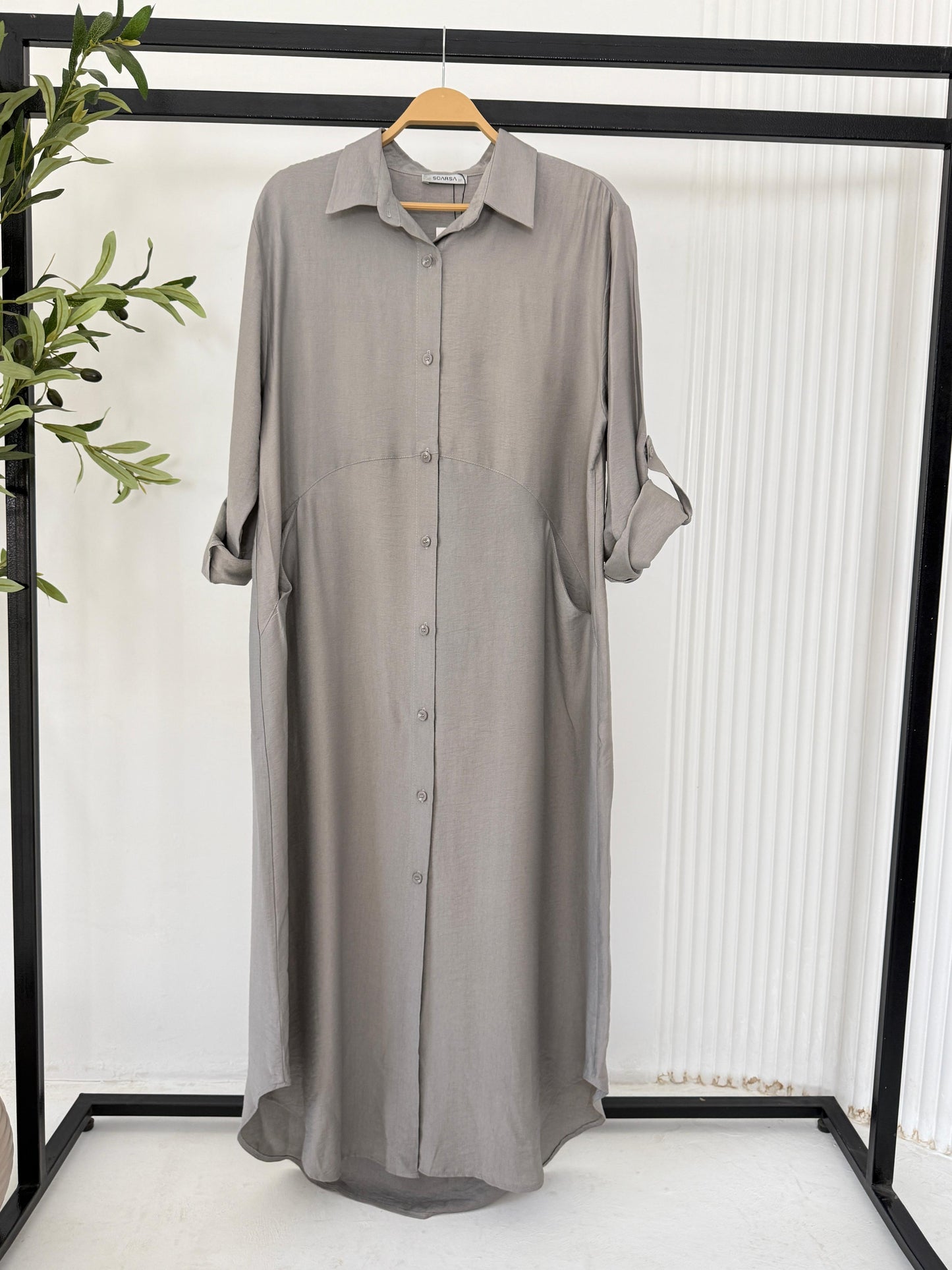 Amenaa shirt dress in light fabric, featuring a collar, button-down front, and short sleeves, displayed on a hanger.