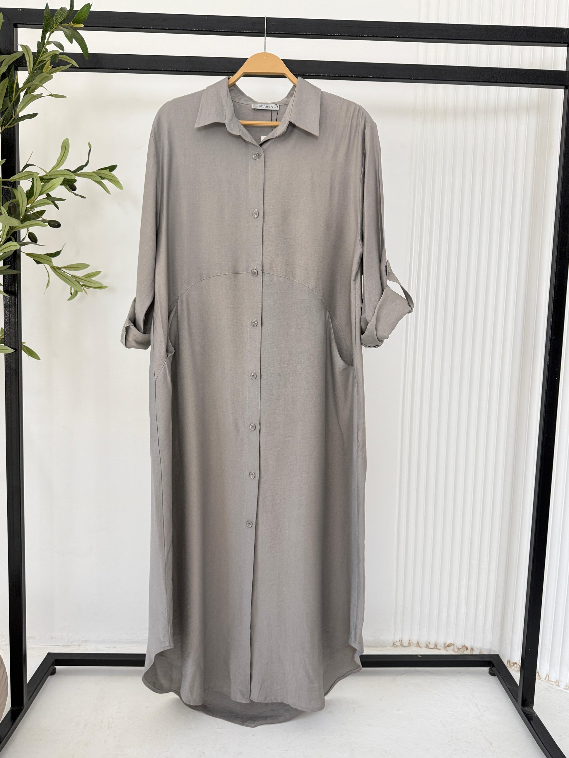 Amenaa shirt dress in light fabric, featuring a collar, button-down front, and short sleeves, displayed on a hanger.