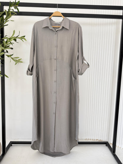 Amenaa shirt dress in light fabric, featuring a collar, button-down front, and short sleeves, displayed on a hanger.