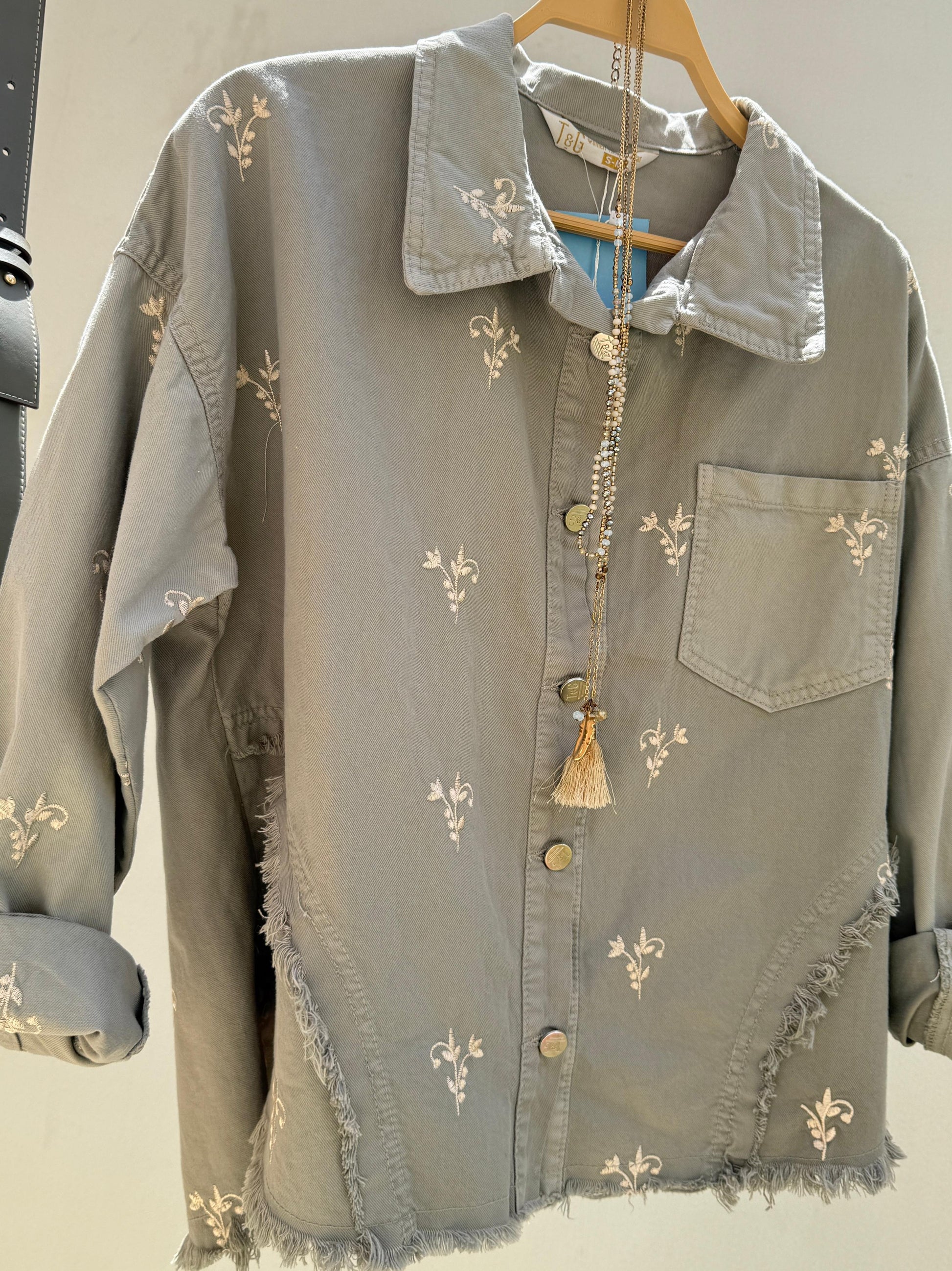 Flowery embroidered gabardine jacket by Amenaa featuring vibrant floral embroidery and a tailored fit.